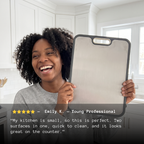 Customer holding the double-sided titanium cutting board in her kitchen