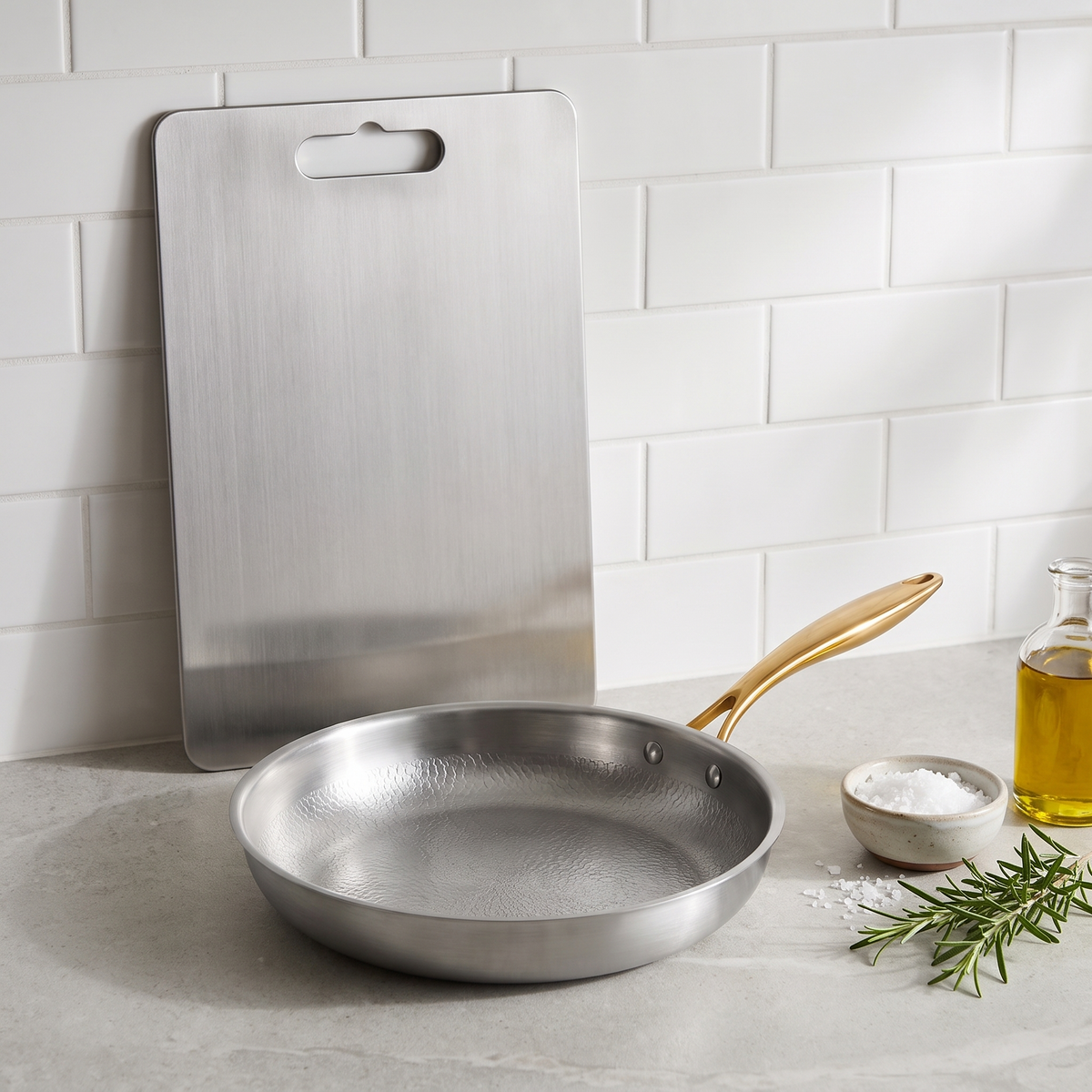 Titanium cutting board and titanium frying pan on a kitchen counter