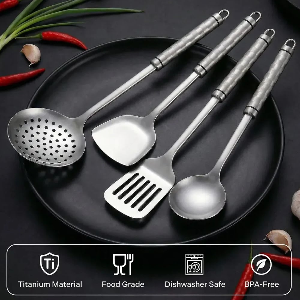 Four titanium utensils on a black plate