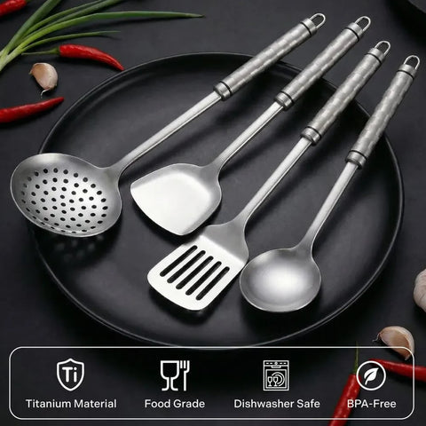 Four titanium utensils on a black plate